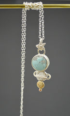 celestial pendant necklace with round blue turquoise, mixed metal dot planets and star shaped bail. On a silver chain.