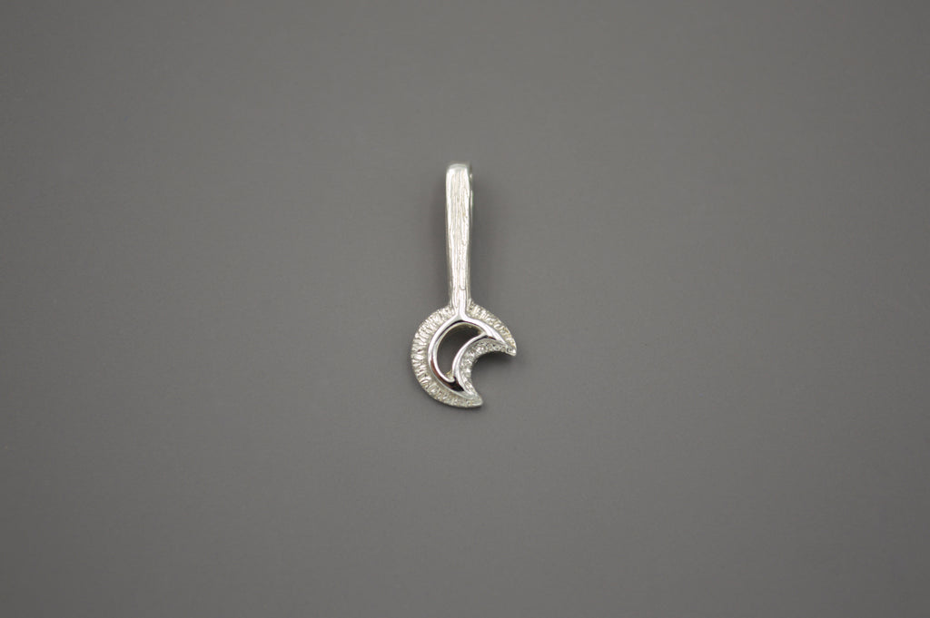 Silver moon wand pendant. The crescent moon shape sits at the end of a textured wand.