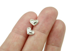 Silver tone Heart Earrings shown in hand