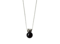 black onyx sphere hangs from a star encrusted pendant on a sterling silver chain.