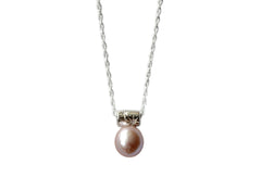 pink pearl hangs from a star encrusted bail on a sterling silver chain