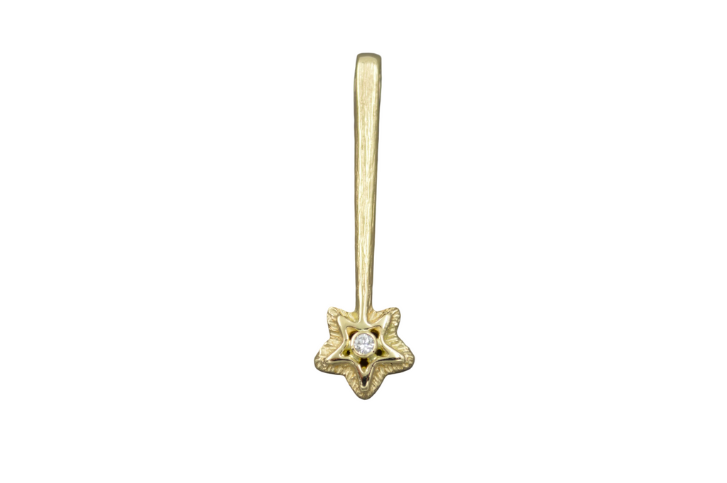 14k yellow gold star wand shaped pendant with a white diamond in the center of the star.