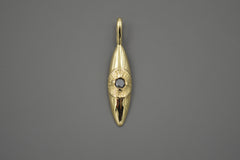 14k gold eye pendant that hangs vertically. The pupil of the eye is a faceted black diamond. Shown laying on a hand.