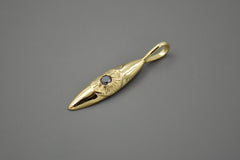 14k gold eye pendant that hangs vertically. The pupil of the eye is a faceted black diamond. 