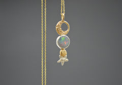 14k and sterling silver Mixed metal celestial pendant necklace with Australian opal, gold crescent moon, planet, and silver star detail