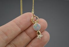 14k and sterling silver Mixed metal celestial pendant necklace with Australian opal, gold crescent moon, planet, and silver star detail