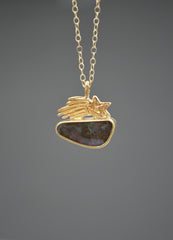 Gold Necklace with a shooting star sitting on top of an Australian boulder opal on a gray background