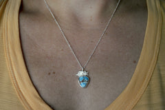 Silver Golden Hills Turquoise Necklace with a shooting star. On model wearing an orange shirt
