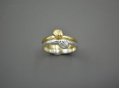 Gold and silver bands stacked together with ladybug detail