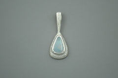 Teardrop-shaped wand pendant with a boulder opal gemstone on a gray background