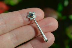 Silver and 14k star wand pendant with a black spinel gemstone on fingertips
