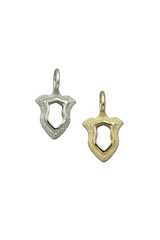 Two shield-shaped pendants, one silver and one gold, on a white background.