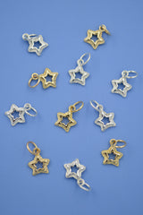 Star-shaped pendants in gold and silver on a blue background