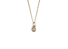 14k rose gold necklace with a tiny star shaped pendant that has a diamond set within.