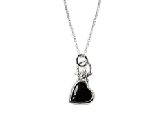 A black onyx heart with a star on top of it and a textured bail. Necklace is sterling silver.