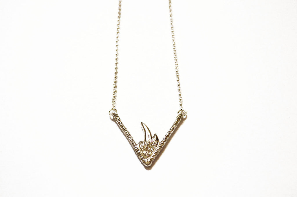 Silver necklace with triangular flame pendant