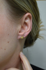 Gold tone Heart Earrings on model's ear