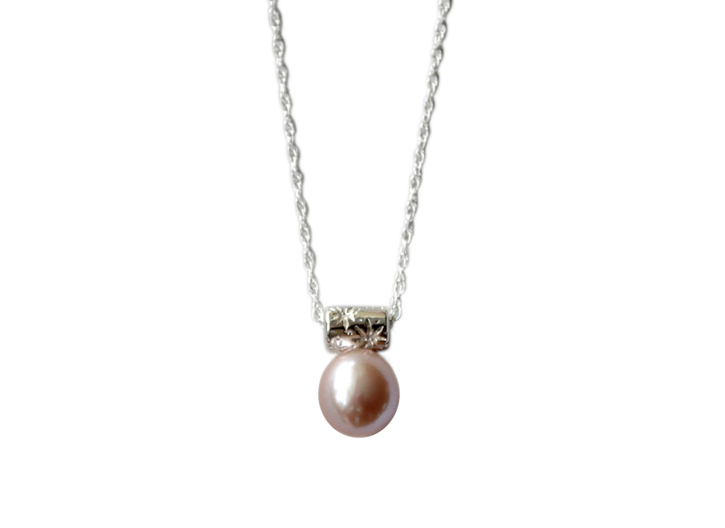 pink pearl hangs from a star encrusted bail on a sterling silver chain